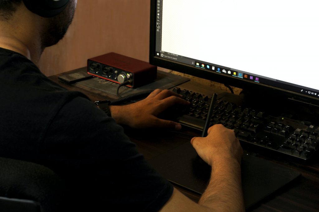 person in black long sleeve shirt using computer